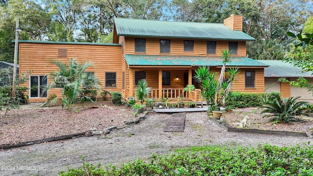 7816 Whispering Pines Ln, Glen St Mary, FL 32040 - view of front of property featuring covered porch, a chimney, and metal roof