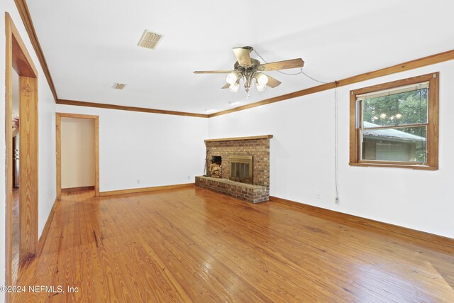 7816 Whispering Pines Ln, Glen St Mary, FL 32040 - unfurnished living room with ceiling fan, crown molding, light wood-type flooring, baseboards, and a brick fireplace