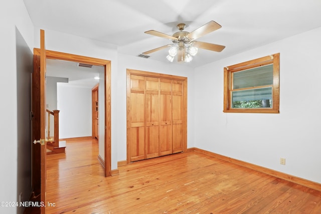 unfurnished bedroom with a closet, ceiling fan, and light hardwood / wood-style flooring