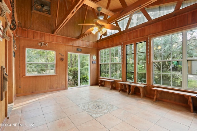 unfurnished sunroom with lofted ceiling with beams and ceiling fan