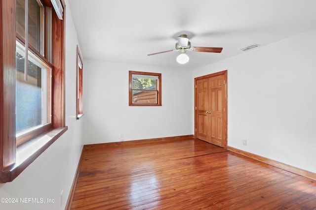 empty room with wood-type flooring and ceiling fan