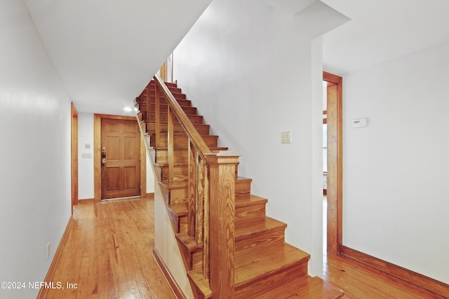7816 Whispering Pines Ln, Glen St Mary, FL 32040 - staircase featuring wood-type flooring and baseboards