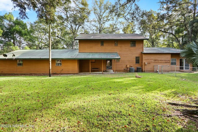 7816 Whispering Pines Ln, Glen St Mary, FL 32040 - rear view of house featuring metal roof and central AC unit