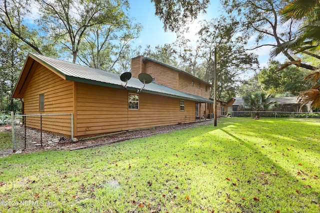 view of home's exterior with a lawn