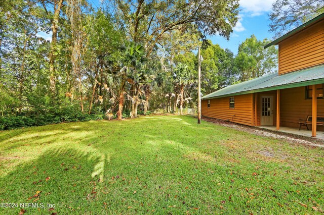7816 Whispering Pines Ln, Glen St Mary, FL 32040 - view of green lawn with a patio