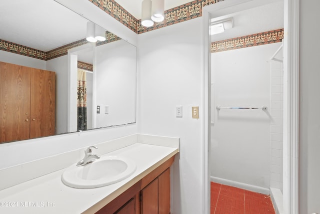 bathroom with vanity and a shower