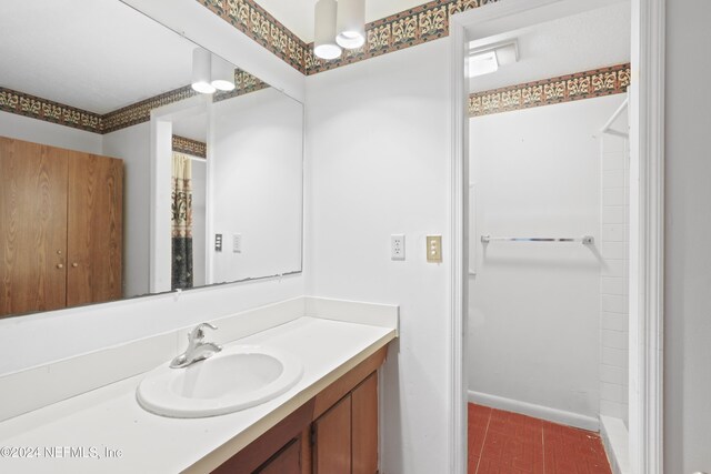 7816 Whispering Pines Ln, Glen St Mary, FL 32040 - bathroom with vanity, a shower with shower curtain, and baseboards