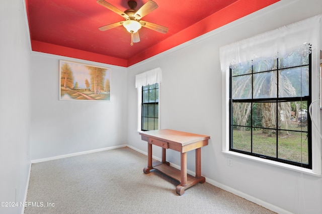 carpeted spare room with plenty of natural light and ceiling fan