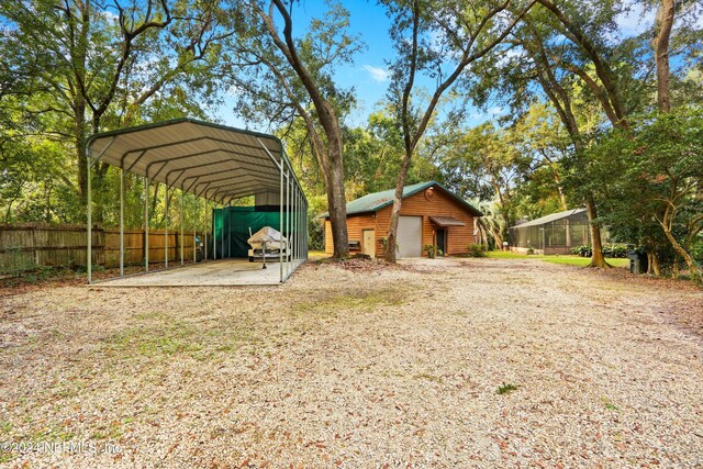 7816 Whispering Pines Ln, Glen St Mary, FL 32040 - view of yard featuring a garage, a detached carport, and driveway