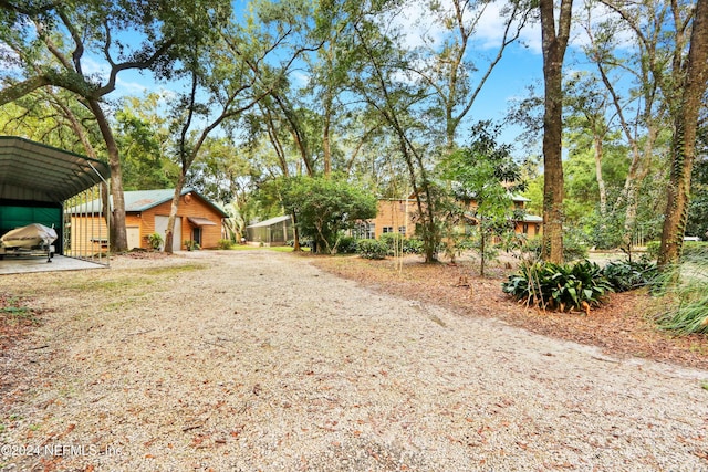 7816 Whispering Pines Ln, Glen St Mary, FL 32040 - view of yard with a carport and a garage