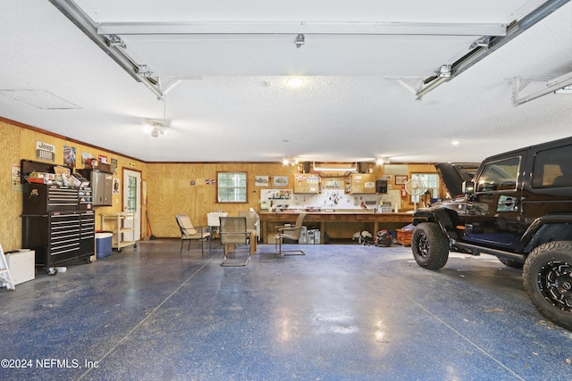 7816 Whispering Pines Ln, Glen St Mary, FL 32040 - garage featuring wood walls and a workshop area
