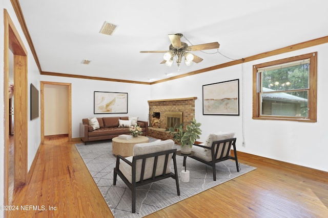 7816 Whispering Pines Ln, Glen St Mary, FL 32040 - living area featuring wood finished floors, a ceiling fan, crown molding, a brick fireplace, and baseboards