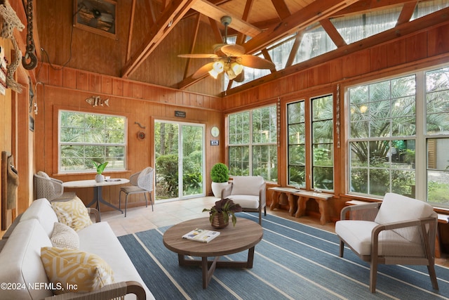 sunroom featuring ceiling fan and lofted ceiling with beams