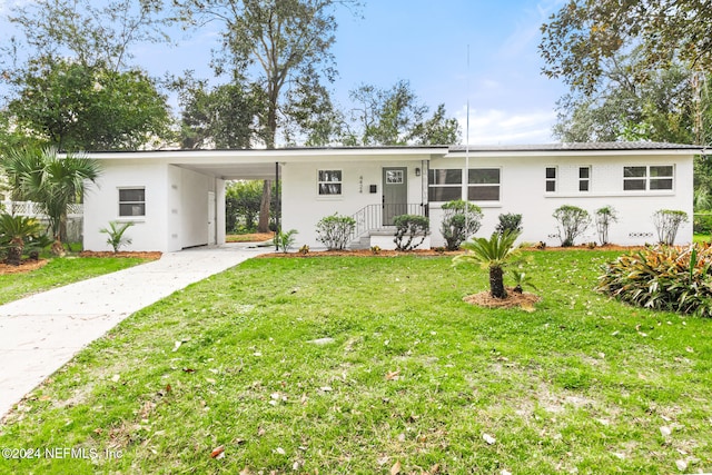 ranch-style house with a front yard and a carport