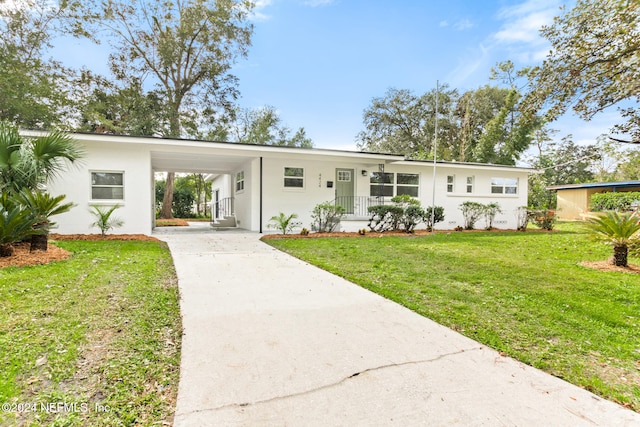 ranch-style home featuring a front yard and a carport