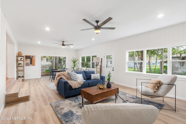 living room featuring ceiling fan, light hardwood / wood-style floors, and plenty of natural light