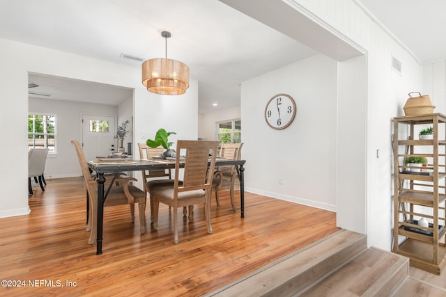 dining room featuring light hardwood / wood-style floors and a notable chandelier