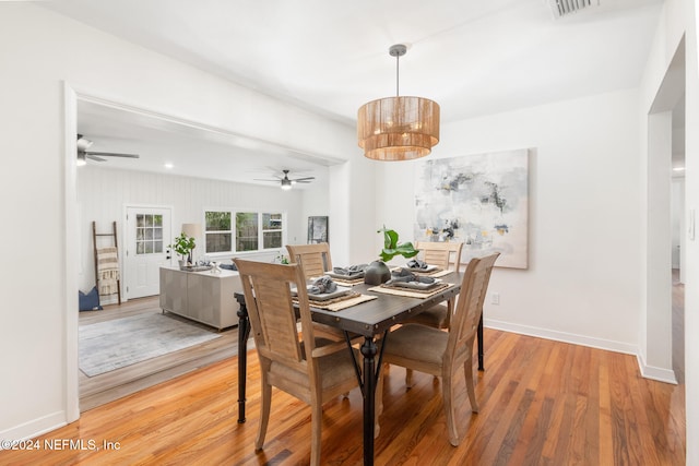 dining space featuring wood-type flooring and ceiling fan