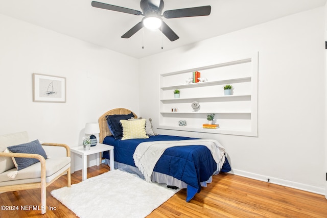 bedroom with light hardwood / wood-style floors and ceiling fan