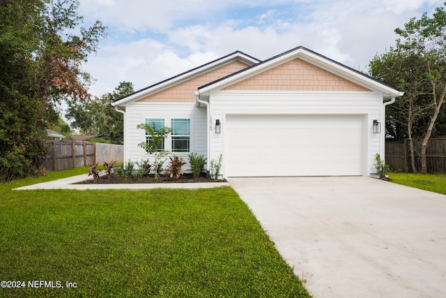 view of front facade with a garage and a front yard