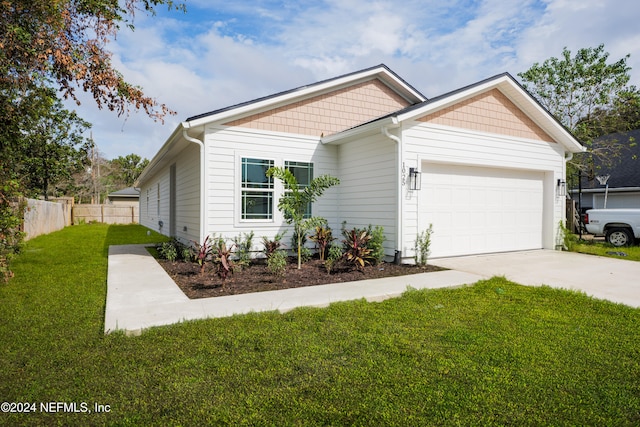 view of front of property featuring a front yard and a garage