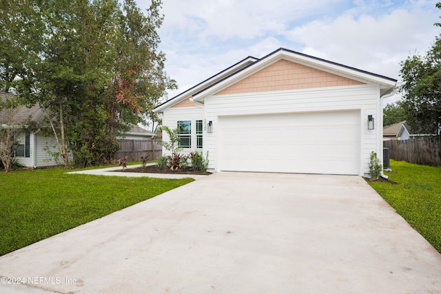 single story home with central air condition unit, a garage, and a front lawn