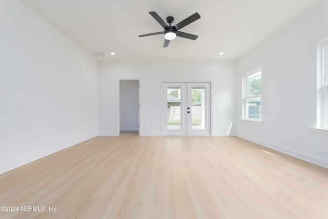 spare room with light hardwood / wood-style floors, ceiling fan, and french doors