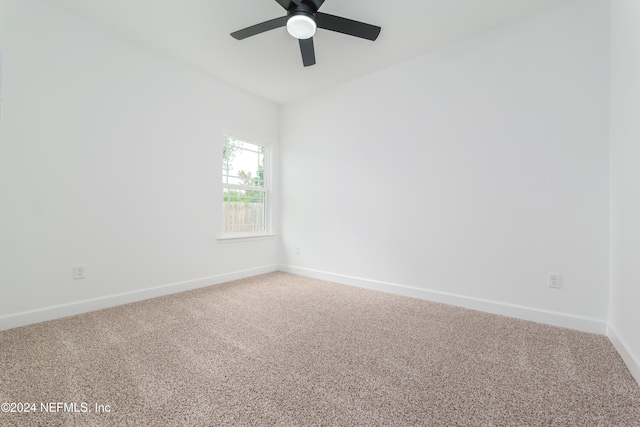 unfurnished room featuring ceiling fan and carpet