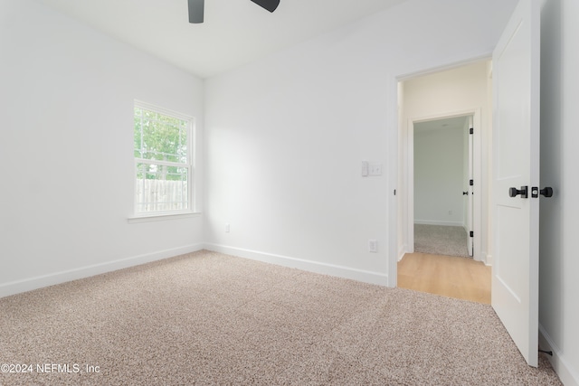 carpeted empty room with ceiling fan