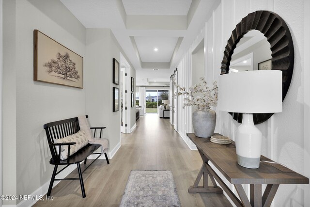 hallway with light hardwood / wood-style floors