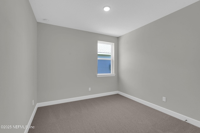 807 Goldenrod Dr, Saint Augustine, FL 32092 - empty room with dark colored carpet and baseboards