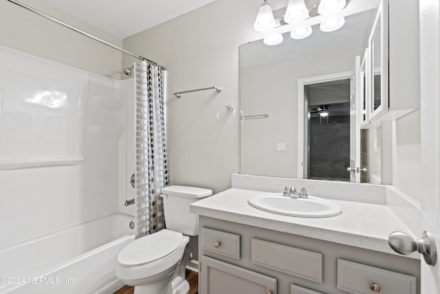 full bathroom with hardwood / wood-style flooring, vanity, shower / bath combination with curtain, and toilet