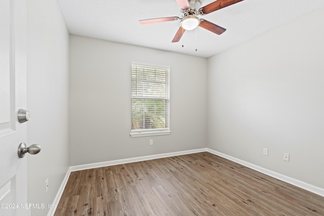 spare room featuring hardwood / wood-style flooring and ceiling fan