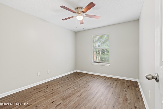 spare room featuring a textured ceiling, hardwood / wood-style floors, and ceiling fan