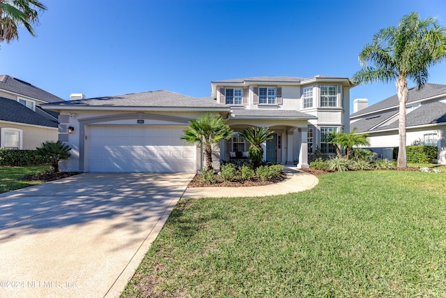 view of front of house featuring a garage and a front lawn