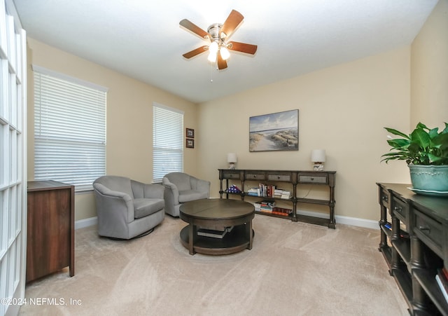 carpeted living room featuring ceiling fan