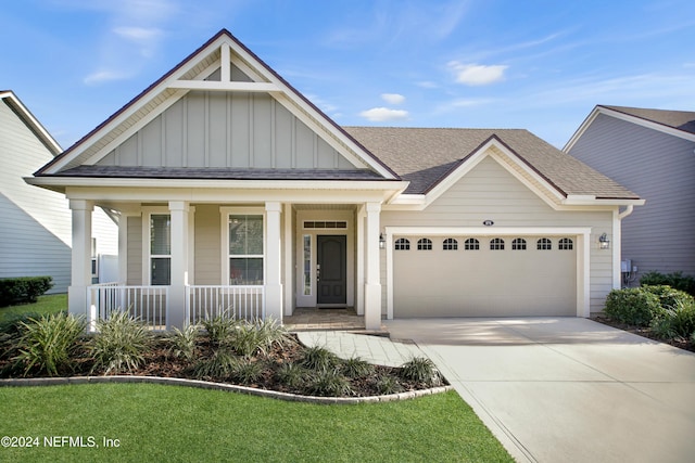 view of front of home with a porch and a garage