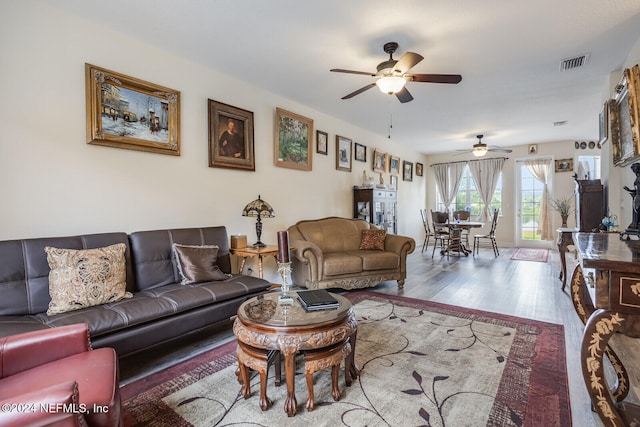 living room with light hardwood / wood-style floors and ceiling fan