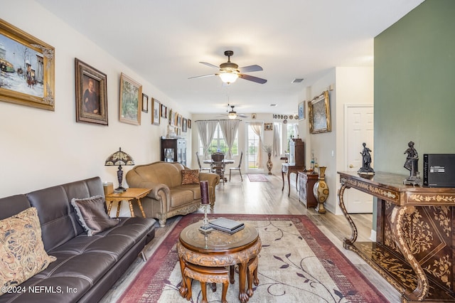 living room featuring ceiling fan and wood-type flooring