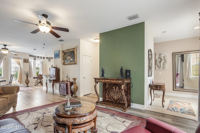 living room with light wood-type flooring and ceiling fan