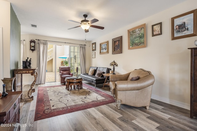 living room with wood-type flooring and ceiling fan