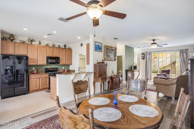 dining area featuring light hardwood / wood-style floors and sink