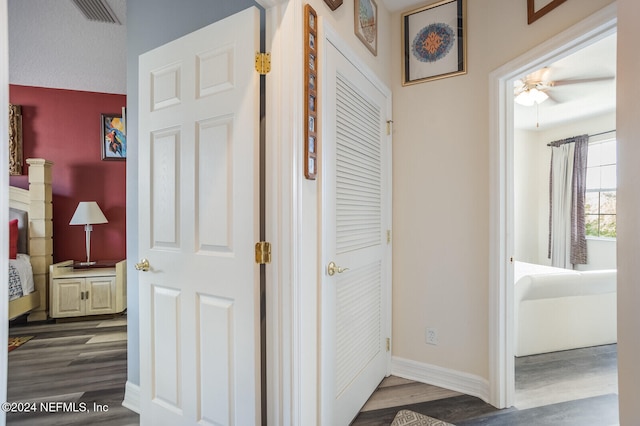 corridor featuring dark wood-type flooring