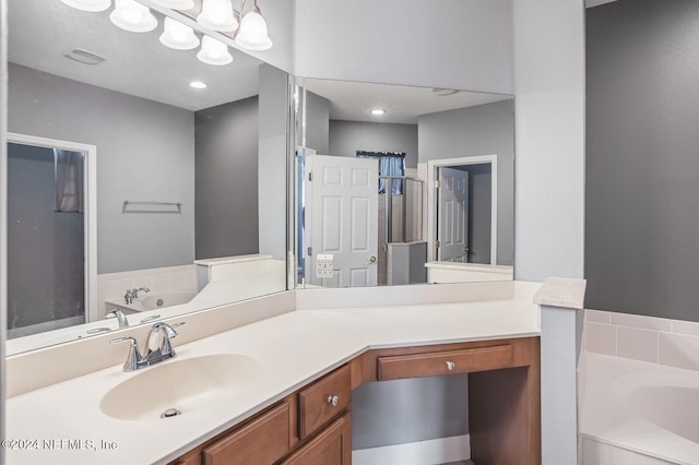 bathroom featuring vanity and separate shower and tub