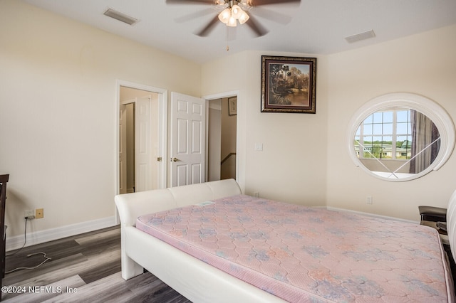 bedroom with dark hardwood / wood-style floors and ceiling fan