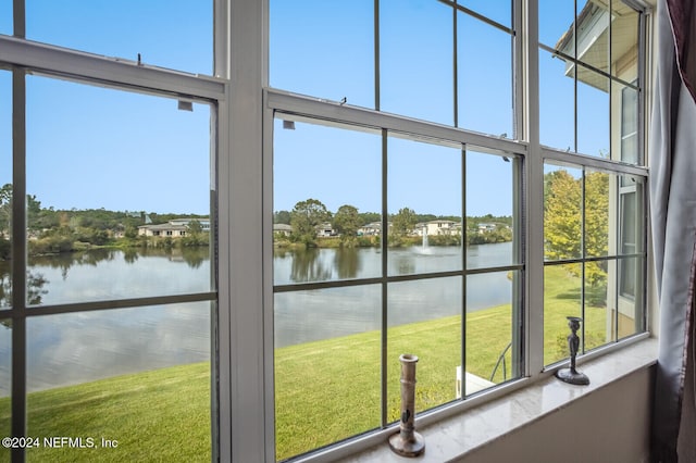 doorway to outside with a water view and a wealth of natural light