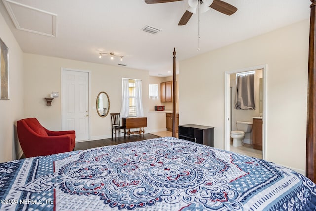 bedroom featuring connected bathroom, ceiling fan, and dark hardwood / wood-style flooring