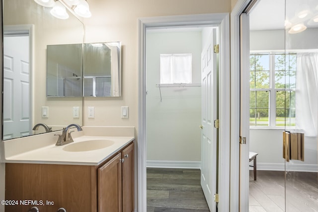 bathroom with vanity, wood-type flooring, and walk in shower