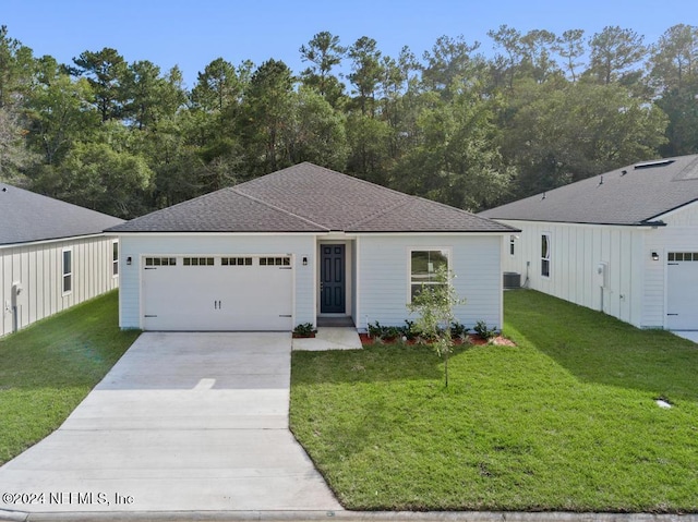 ranch-style home with central air condition unit, a garage, and a front lawn