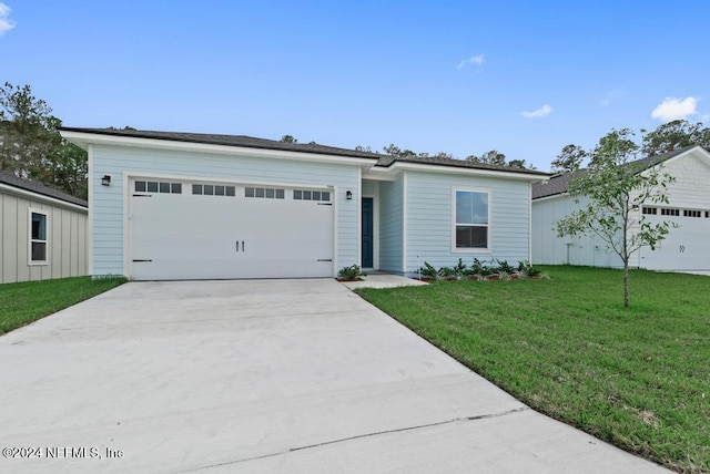 ranch-style home with a front yard and a garage